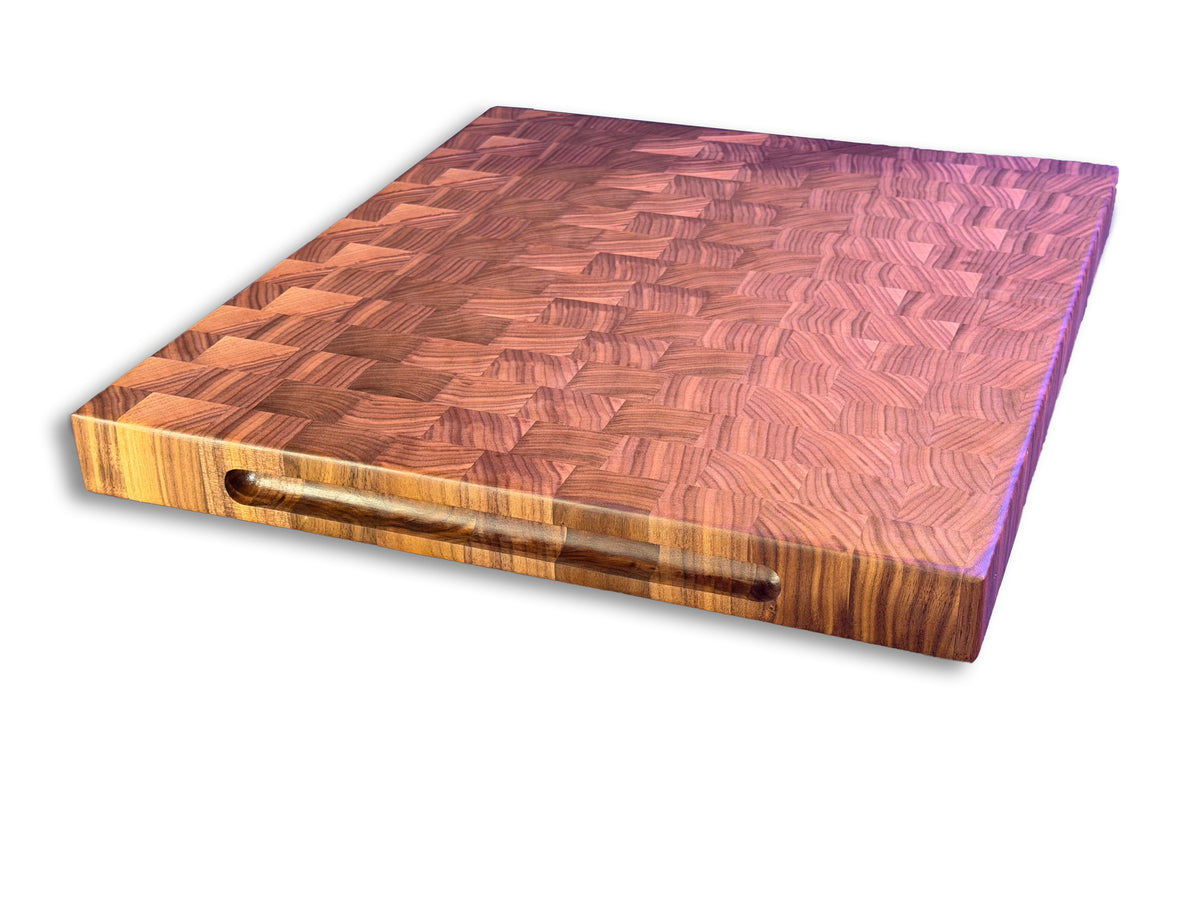 Angled view of an XL walnut end grain brisket board with a full-length recessed handle