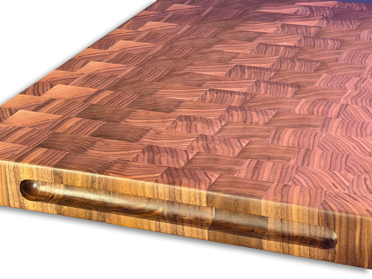 Close-up of the recessed handle and walnut end grain pattern on an XL brisket board